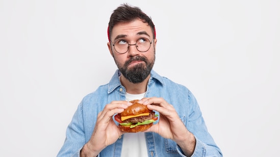 By eating in response to physical hunger, rather than out of boredom or habit, you could cultivate a healthier and more intuitive approach to eating. Nutritionist Eric Berg's 'don't eat if you're not hungry' is a simple yet powerful weight loss tip. It encourages mindful eating and can help develop a healthier relationship with food. According to Eric, by listening to your body's hunger cues, you can avoid overeating, thereby reducing calorie intake and supporting weight loss. Also read | Fitness coach says 'hunger is fat leaving body', shares 5 weight loss cheat codes: Drink water before and after a meal