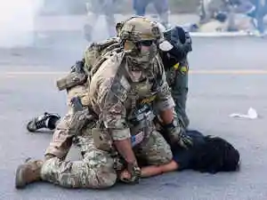 Federal immigration agents are employing increasingly combative tactics in Chicago, including helicopter raids and chemical agents, sparking widespread criticism. Illinois Governor Pritzker condemned these