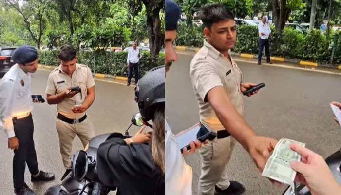 Gurugram traffic police have suspended three officers after a video of them allegedly accepting bribe from a Japanese tourist became viral. Reportedly, the incident occurred on August 25 when Japanese tourist Yamato was riding on a scooty with a female friend.<br> <br> The pair were stopped near a U-turn by traffic police. Yamato's friend was wearing a helmet but he was not, which was a common violation seen on roads that day. The officers demanded an on-the-spot fine of Rs 1,000 in cash, they refused digital payments and declined to issue any official receipt. Yamato handed over two Rs 500 notes, which were filmed being counted by the officers. The police also took the woman's phone number and instructed her to call them directly if stopped again elsewhere.