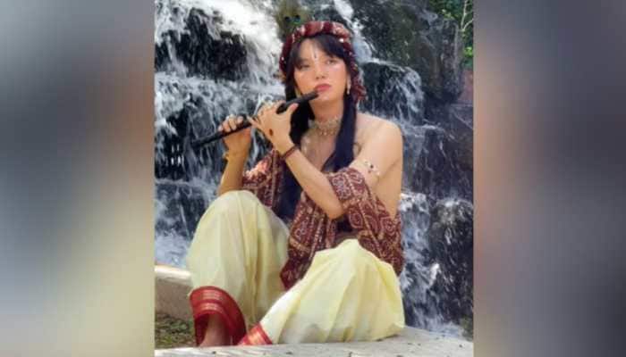 In a viral video on Instagram, a South Korean man is dressed in Lord Krishna's (Kanha) attire. Netizens are praising this gesture as a beautiful example of the unity of culture. A heartwarming video of a South Korean man dressed as Lord Krishna fondly (Kanha) is being viral on Instagram, sparking joy and admiration across social media.