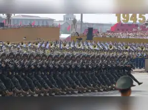 In Chongqing, China, a man projected anti-Communist slogans onto a skyscraper days before a major military parade in Beijing. The slogans called for the end of Communist Party rule, and the projector was remotely operated from Britain. This act of defiance occurred amidst tight censorship and surveillance, highlighting the rare public dissent against the Chinese government.