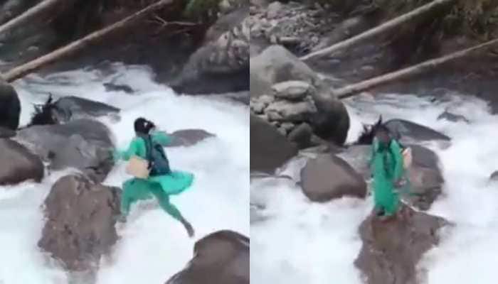 In Himachal Pradesh's Mandi district, a staff nurse has become an example of courage after a video of her crossing a dangerous overflowing stream went viral. In Himachal Pradesh's Mandi district, a staff nurse has become an example of courage after a video of her crossing a dangerous overflowing stream went viral.