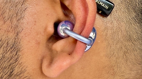 In India's bustling urban landscape, the Huawei FreeClip offers an intriguing option for those seeking open-ear audio with a fashionably futuristic twist. Here's what makes them decent, and where they fall short. The standout feature of the FreeClip is its open-ear C-bridge design, resembling a thin, flexible clip that hooks onto your ear cartilage. This keeps the earbuds securely in place without entering your ear canal, allowing you to stay aware of ambient sounds, ideal for commuters or multitaskers.