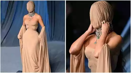 Kim Kardashian completely covers her head as she attends the Academy Museum Gala