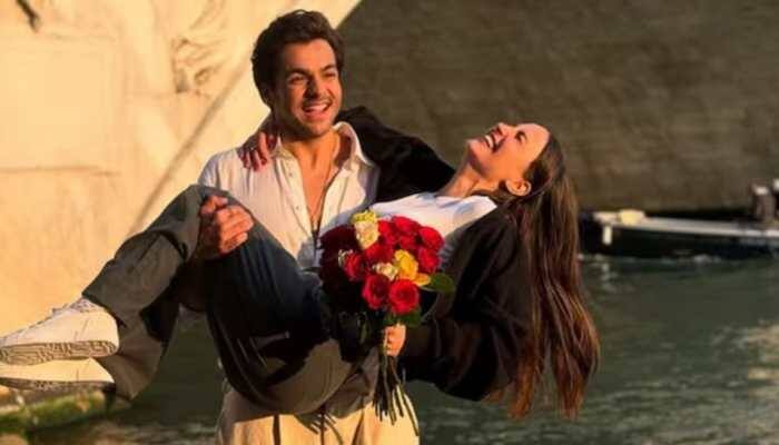 New Delhi: Popular YouTuber Ashish Chanchlani has set social media abuzz after sharing a romantic photo with actress Elli AvrRam, fueling speculation about whether the two are officially a couple or not. In the photo, Elli is seen laughing while being held in Ashish's arms, holding a vibrant bouquet of yellow and red flowers. The picturesque scene is made even more charming by a quaint stone bridge and a serene canal in the background. Ashish is beaming, and the chemistry between the two is hard to miss. The caption, simply reading “Finally,” has only intensified dating rumours, with many fans interpreting it as a soft confirmation of their relationship status.