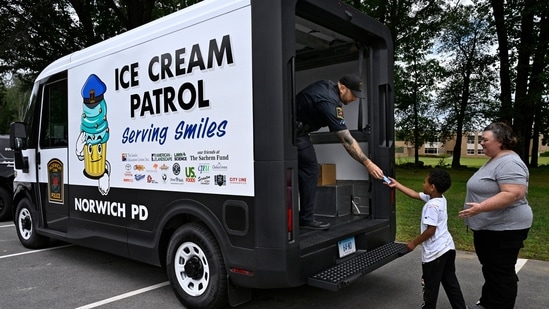 On a humid afternoon in Norwich, Connecticut, the familiar jingle of an ice cream truck floated through the air. But when children dashed outside, they didn't find a neighborhood vendor - they found uniformed police officers, scooping out free Italian ices and popsicles from a van plastered with the words “Copsicle Patrol.”