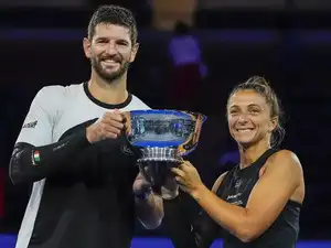 Sara Errani and Andrea Vavassori triumphed over Iga Swiatek and Casper Ruud, securing their second consecutive US Open mixed doubles title and the $1 million prize. The Italian duo's established partnership proved decisive in the revamped competition, which drew singles stars eager for a pre-singles challenge. Errani emphasized the value of dedicated doubles teams after their victory.