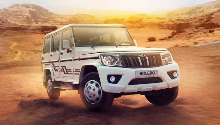 2026 Mahindra Bolero: Mahindra's iconic SUV, the Bolero, is all set for a big makeover in 2026. The next-generation model is already in testing, and recent spy shots hint at what's coming. 2026 Mahindra Bolero Spotted Testing: Mahindra's iconic SUV, the Bolero, is all set for a big makeover in 2026. The next-generation model is already in testing, and recent spy shots hint at what's coming. Even though the testing model was heavily camouflaged, some key design changes are hard to miss, like the boxier and upright stance, a revised grille with vertical slats, new circular LED headlamps with integrated DRLs, and a clamshell bonnet that adds to its rugged appeal.