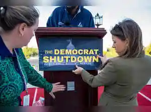 A government shutdown is severely impacting Virginia's economy, particularly its military and civil service sectors, leading to widespread concern among voters. While both parties risk losing support, initial polls suggest more blame falls on Republicans and President Trump. Local elections are already seeing the shutdown as a key issue, with fears of long-term political fallout for both sides.A government shutdown is severely impacting Virginia's economy, particularly its military and civil service sectors, leading to widespread concern among voters. While both parties risk losing support, initial polls suggest more blame falls on Republicans and President Trump. Local elections are already seeing the shutdown as a key issue, with fears of long-term political fallout for both sides.Betty Snellenberg and Grace Cook stood on opposite sides of the walkway into the early voting center in Virginia Beach - one promoting the Democratic ticket for the November 4 statewide election, the other distributing pamphlets for the Republican nominees.<br><br> Flanking the entrance, the two women embodied the country's partisan split as a days-old government shutdown threatened to cleave the political left and right further apart, with each side blaming the other for the paralysis in Washington.<br><br> Yet Snellenberg and Cook shared a common concern: their parties risk losing the messaging war if the shutdown goes on for weeks or months, especially in an area of their state so dependent on civil service and military jobs. Tens of thousands of workers have been furloughed or are working without pay.<br><br> A long shutdown could severely damage the economy of the Hampton Roads area of Virginia, home to multiple military installations, including the world's largest naval base in Norfolk and a base for fighter jets in Virginia Beach.<br><br> Snellenberg, an 84-year-old Democrat, said she was worried that in a prolonged shutdown voters would eventually come to care more about the broader economic toll than the extension of healthcare subsidies that are at the core of Democrats' demands.<br><br> 