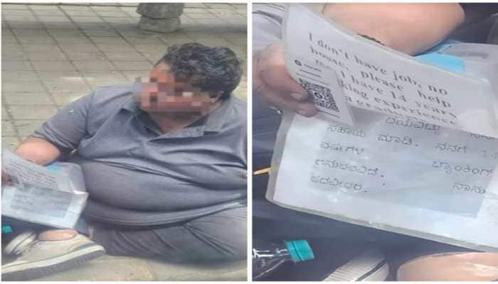 A photo of a former banker sitting on a Bengaluru street with a plea for help sparks emotional debate online about unemployment, mental health and social support. <strong>New Delhi:</strong> At a busy traffic signal in Bengaluru, thousands pass each day. Few stop. But one man sitting quietly by the roadside made the city pause, not with noise, but with a simple sign written by hand.
