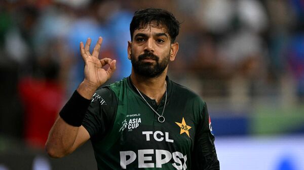 After heated on-field exchanges during the India vs. Pakistan match, cricketer Haris Rauf's wife, Muzna Masood Malik, has stirred a fresh controversy in an Instagram post where she referred to a gesture made by Rauf during the match. ​The controversy began on the field when Rauf was taunted by Indian fans in the UAE about Virat Kohli's famous six off him during the ICC Men's T20 World Cup 2022. Frustrated by that, Rauf made the 