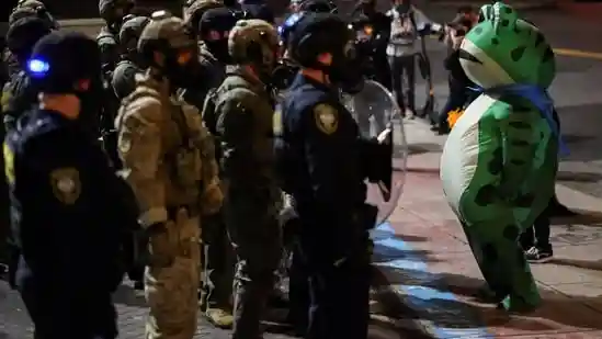 Among all the protestors in Portland, Oregon, one has captured social media's attention for turning up wearing unusual attire - an inflatable frog costume. Since then, videos and pictures of the protestor, dubbed the Portland Frog, have taken over social media.Among all the protestors in Portland, Oregon, one has captured social media's attention for turning up wearing unusual attire - an inflatable frog costume. Since then, videos and pictures of the protestor, dubbed the Portland Frog, have taken over social media.The person said they chose the costume to harmlessly protest “with humour.