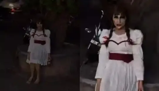 The viral video begins with the woman, covered in realistic makeup, stepping out onto a crowded street as pedestrians pause to look in disbelief