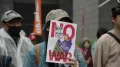 On a Tokyo street corner, in the pouring rain, a swelling crowd gathered with drenched placards and sodden flags. On one of them was written just two words