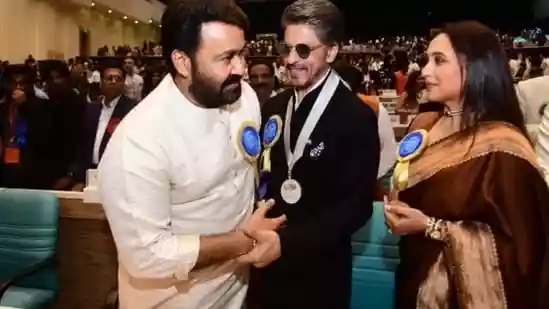 Bollywood stars Shah Rukh Khan, Rani Mukerji, and Malayalam star Mohanlal bumped into each other at the National Film Awards in Delhi on Tuesday afternoon. They shared a sweet moment that did not go unnoticed by fans who are now calling it ‘iconic' on social media. Take a look.