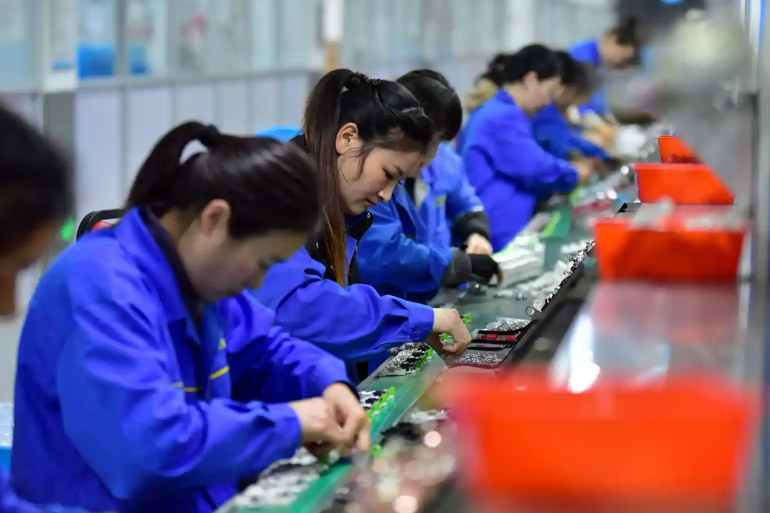 It's a sombre gathering in the backstreets of one of China's biggest manufacturing hubs, where workers are smoking under a tree in front of storefronts