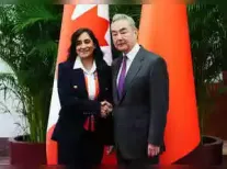 China's Foreign Minister Wang Yi expressed willingness to boost ties with Canada, emphasizing the need to remove 