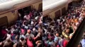 A now-viral clip showing passengers desperately pushing and struggling to board an overcrowded train has triggered a heated debate on social media