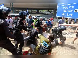 Demonstrators waved Israeli flags and carried photos of hostages as whistles, horns, and drums echoed at rallies across the country, while some protesters blocked streets and highways, including the main route between Jerusalem and Tel Aviv. TEL AVIV/JERUSALEM: Thousands of Israelis took part in a nationwide strike on Sunday in support of families of hostages held in Gaza, calling on Prime Minister Benjamin Netanyahu to reach an agreement with Hamas to end the war and release the remaining captives.<br><br>Demonstrators waved Israeli flags and carried photos of hostages as whistles, horns, and drums echoed at rallies across the country, while some protesters blocked streets and highways, including the main route between Jerusalem and Tel Aviv.<br><br>“Today, everything stops to remember the highest value: the sanctity of life,” Anat Angrest, the mother of hostage Matan Angrest, told reporters at a public square in Tel Aviv.<br><br>Among those who met with families of hostages in Tel Aviv was Israeli Hollywood actress Gal Gadot, known for her role as Wonder Woman and starring in the Fast & the Furious franchise.<br><br>Ahead of Sunday, some businesses and institutions said they would allow staff to join the nationwide strike, which was called by the hostages' families. While some businesses closed, many also remained open across the country on what is a working day in Israel. Schools are on summer recess and were not affected.<br><br>A major rally is scheduled to take place in Tel Aviv in the evening.<br><br>Israeli police said that 38 demonstrators had been detained by 2 p.m. (11 a.m.