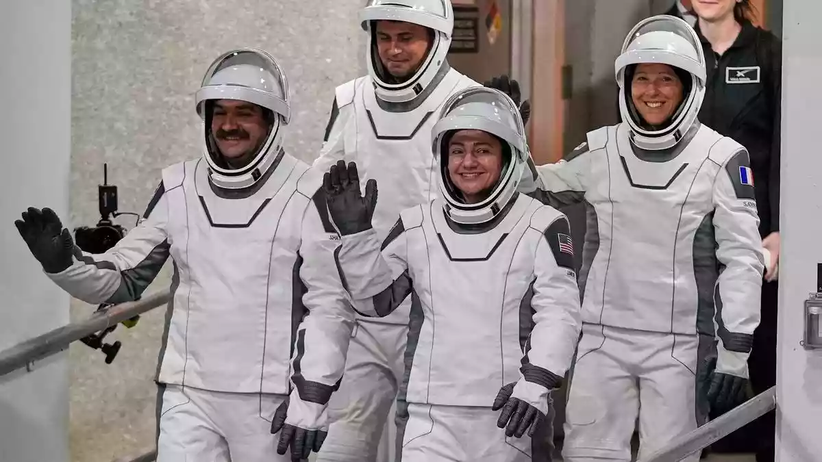 The International Space Station returned to full strength with the arrival of four new astronauts to replace colleagues who bailed early because of health