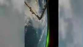 The video, captured from space, showcases the Aurora Borealis like never before. From thousands of kilometers above, the lights shimmer and twist over the