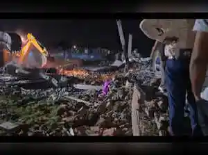 In Ayodhya's Pagla Bhari village, a house collapsed following a powerful explosion on Thursday, killing at least five people and injuring several others, officials said. Rescue teams, including police and fire department personnel, are using excavators to search for those still trapped under the debris. Nearby homes have been evacuated as a precaution.In Ayodhya's Pagla Bhari village, a house collapsed following a powerful explosion on Thursday, killing at least five people and injuring several others, officials said. Rescue teams, including police and fire department personnel, are using excavators to search for those still trapped under the debris. Nearby homes have been evacuated as a precaution.Ayodhya (UP), At least five people were killed and several others were injured after a house collapsed following a powerful explosion in Pagla Bhari village under the Pura Kalandar police station area of Ayodhya on Thursday, officials said.<br><br>Circle Officer (CO) Shailendra Singh told PTI that several people were still feared trapped under the debris, and rescue operations were underway. 