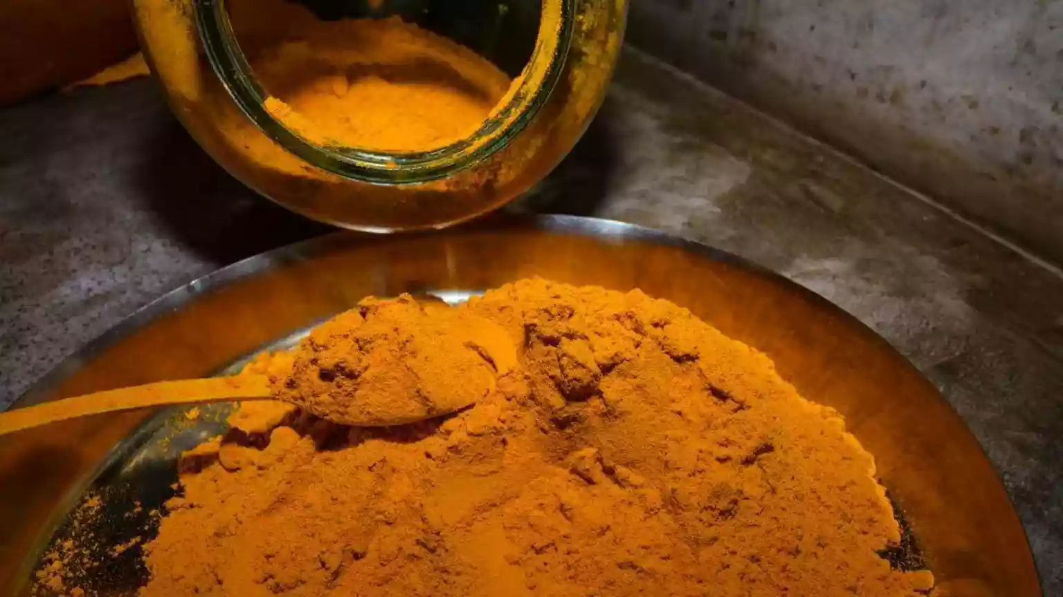 Inside her kitchen in the Indian capital, Delhi, 55-year-old Nirmal Rao lays out a tray of boiled turmeric to dry in the afternoon sun