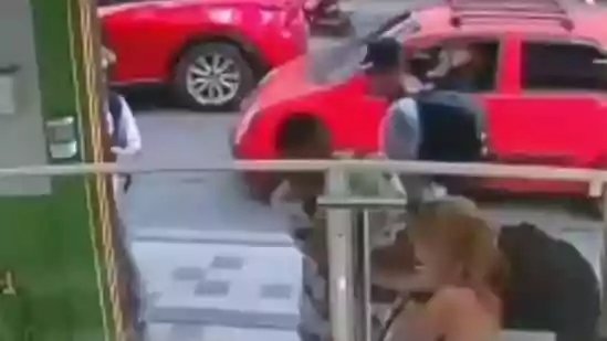 A viral video shows a young woman bravely fighting off an attacker while her male companion backs away in fear and even hides behind a wall