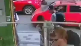 A viral video shows a young woman bravely fighting off an attacker while her male companion backs away in fear and even hides behind a wall