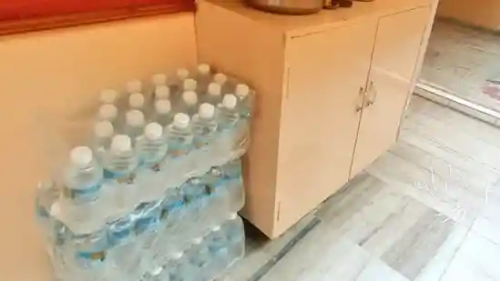 Man keeps water bottles outside his house for delivery partners