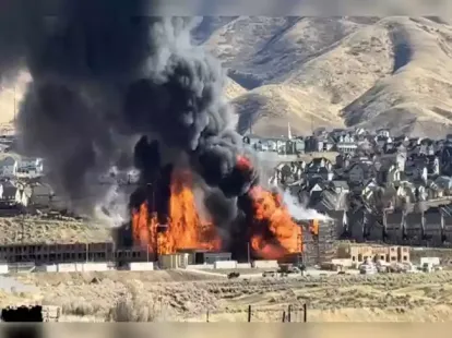 A massive fire engulfed multiple structures at an apartment complex under construction on Traverse Mountain in Lehi, Utah, on Sunday