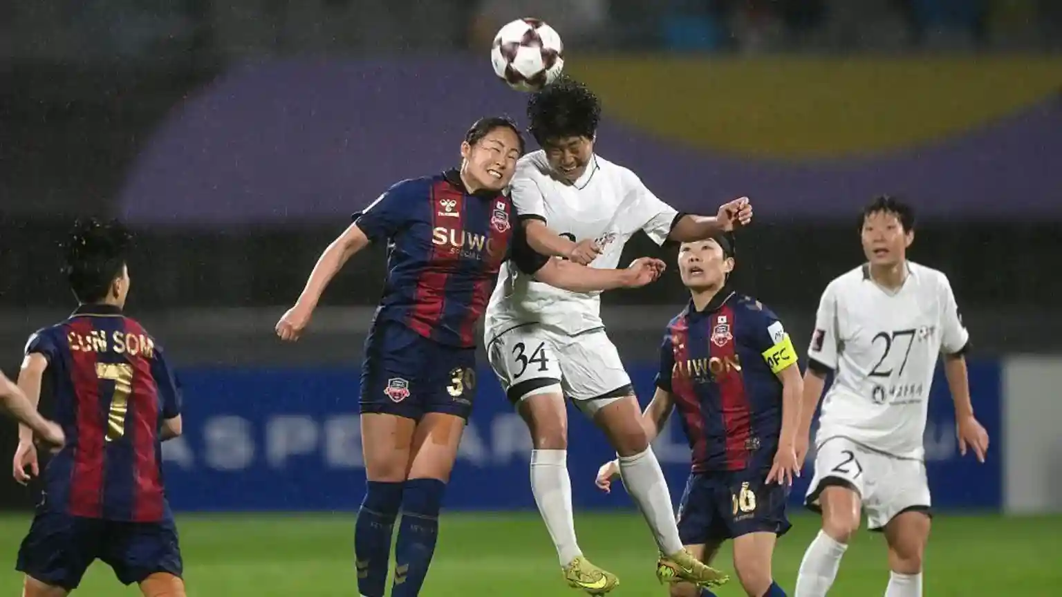 Pounding rain and strong winds did not stop more than 5,000 spectators from turning up at a football stadium in Suwon, just south of Seoul, on Wednesday night
