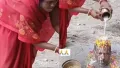 A viral video shows a woman performing a full Vedic pooja on her husband's head while his body remains buried underground. From milk abhishek to 'Har Har