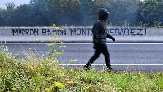 Protesters blocked roads, set blazes and were met with volleys of police tear gas Wednesday in Paris and elsewhere in France, seeking to heap pressure on President Emmanuel Macron by attempting to give his new prime minister a baptism of fire. The interior minister announced nearly 200 arrests in the first hours of the planned day of nationwide protests.