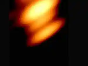 Scientists have captured the first radio image of two supermassive black holes orbiting each other. This event occurred inside a quasar named OJ287, located billions of light-years away. The image validates a long-held prediction about these celestial bodies. The black holes were detected through particle jets and glowing gas. This groundbreaking observation confirms the existence of orbiting black hole pairs.Scientists have captured the first radio image of two supermassive black holes orbiting each other. This event occurred inside a quasar named OJ287, located billions of light-years away. The image validates a long-held prediction about these celestial bodies. The black holes were detected through particle jets and glowing gas. This groundbreaking observation confirms the existence of orbiting black hole pairs.Black holes have been one of the biggest mysteries of the universe. The gravity in them is so intense that even light can not pass through them. <br><br>According to Einstein's theory of general relativity, time slows down as one approaches block hole's event horizon. To a distant observer, clocks near the black hole appear to tick ever more slowly.<br><br>According to the theory, this relationship between time and gravity impacts how we perceive the black hole. When objects orbit or fall into black holes, their motion and light signals are distorted by both gravity and the time wrap. <br><br>These distortions make telescopic observations even more tricky. And this is partly why capturing two black holes locked in orbit has been such a challenge. However, for the first time ever, astronomers have captured a radio image of two supermassive black holes orbiting each other inside a quasar called OJ287, roughly 5 billion light-years away. <br><br>The visual evidence now validates a prediction long suspected but never seen directly. OJ287 has been under observation for over a century. <br><br>In the 1980s, Finnish astronomer Aimo Sillanpää observed that its brightness surged and dipped on a consistent 12‑year cycle, hinting that two black holes might be interacting. The theory has now been validated with the new new radio image. “The two black holes were there in the image, just where they were expected to be,” said Mauri Valtonen of the University of Turku in a press release.<br><h4><br>How were the black holes detected?</h4>Since black holes do not emit light of their own, astronomers detected them via particle jets and g