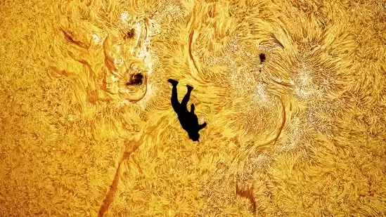 A US based photographer has stunned social media users with an extraordinary photograph that appears to show a skydiver perfectly aligned with the face of the