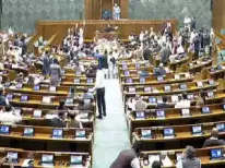 In a dramatic display of political defiance, several suspended opposition MPs rallied outside Parliament on Friday, unfurling a banner that labeled the