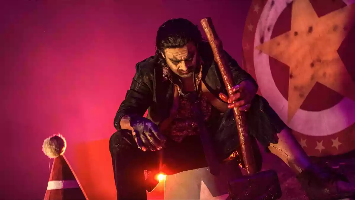 Early on in The Raja Saab, a health scare prompts Prabhas to ask comedian Mahesh Achanta to fetch an odd assortment of items, from footwear to cigarettes