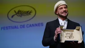 Hollywood star John Travolta has been surprised with an honourary Palme d'Or, the Cannes equivalent of a lifetime achievement award