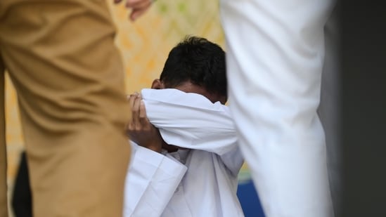 Two men in Indonesia's conservative Aceh province were among a group of people publicly caned on Tuesday after an Islamic Shariah court convicted them of violating Islamic law by hugging and kissing, which the court ruled can lead to banned sexual relations.