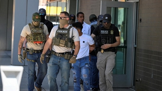 Under President Donald Trump, the Immigration and Customs Enforcement agency has become the driving force of his sweeping crackdown on migrants, bolstered by record funding and new latitude to conduct raids, but staff are contending with long hours and growing public outrage over the arrests.