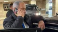 A photograph of Israeli Prime Minister Benjamin Netanyahu speaking on a smartphone, with the area around the camera appearing to be taped