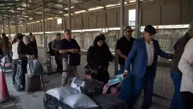 To speak with his mother inside Iran, Yaser Fattahi waits in self-exile in Iraq for brief calls arranged by a cousin back home who travels close to the border