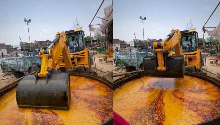 What was meant to be “innovative” has instead sparked outrage. A viral video shows a JCB, usually seen at construction sites, stirring dal makhni, a stunt many called unsafe, unhygienic, and downright disgusting, leaving social media stunned and disgusted.