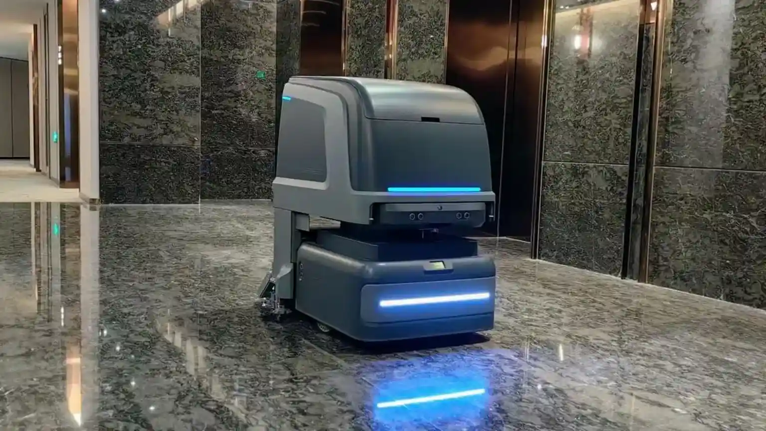 In a hotel lobby on Hong Kong Island, a delivery robot pauses outside one of the lifts as the doors open, and a guest steps out. The robot waits
