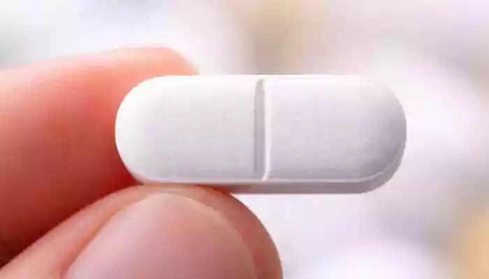 It is called a score line. It is is a mark placed on a tablet to make it easier to split into smaller doses. If you have ever taken a medicine tablet