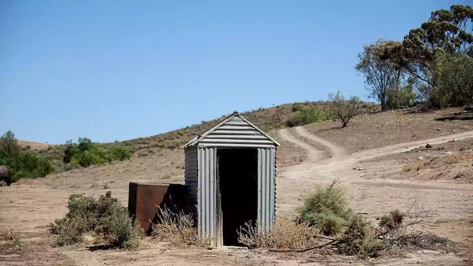 A woman who was taking a toilet break while on a road trip in the Australian outback ended up getting stuck waist-deep in a pit latrine after it collapsed